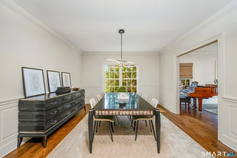 a dining room with furniture a rug and wooden floor