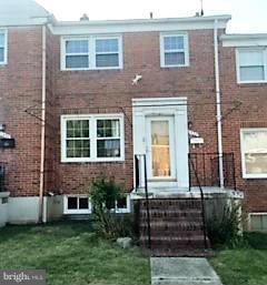 1452 Barrett Road Baltimore, MD 21207 - Photo 1 of 18 a front view of a house with garden
