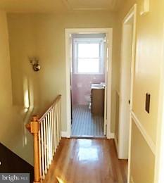 1452 Barrett Road Baltimore, MD 21207 - Photo 13 of 18 a view of a hallway with wooden floor and staircase