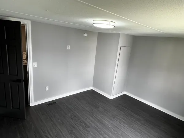 a bathroom with a sink a mirror and wooden floor