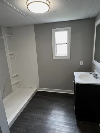 a view of a hallway with wooden floor