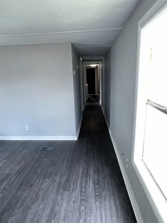 a view of a kitchen from a hallway