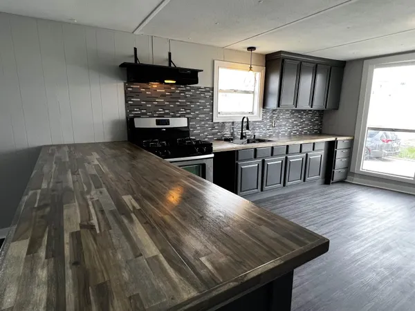 a kitchen with wooden floors and a sink