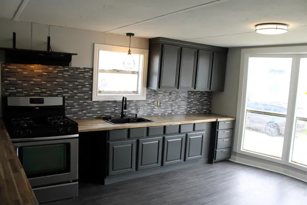 a kitchen with a sink stove and cabinets