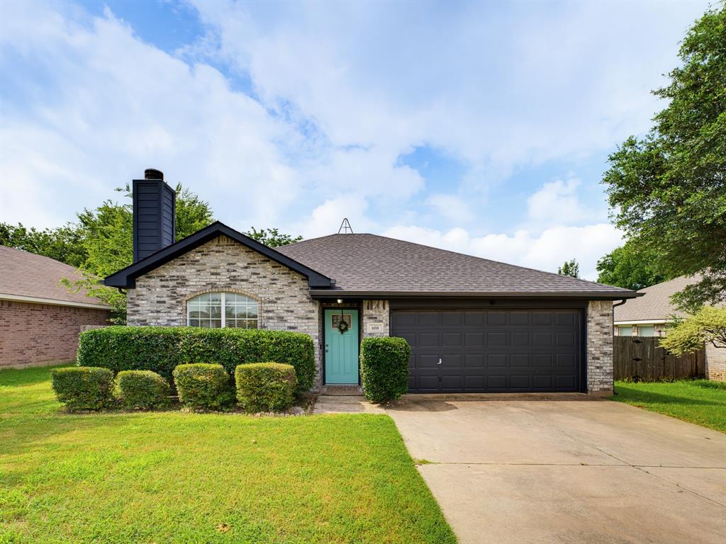 Brick facade with a contrasting turquoise entry door and a two-car garage