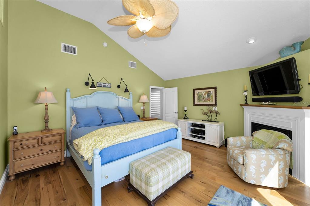 13303 Gulf Lane Madeira Beach, FL 33708 - Photo 16 of 42 a bedroom with a bed and a flat screen tv
