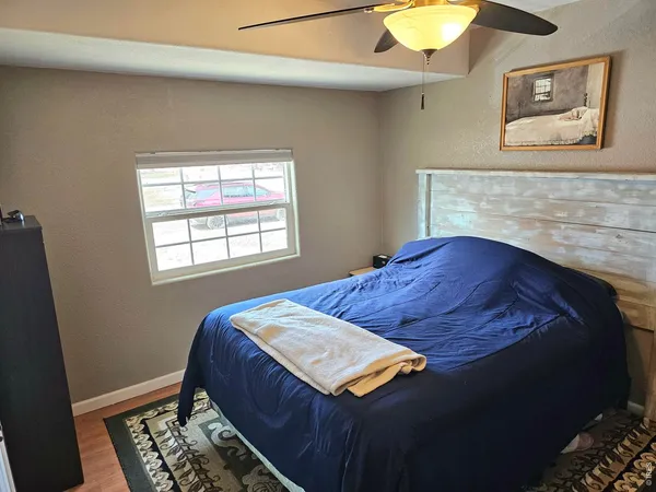 a bed sitting in a bedroom next to a window