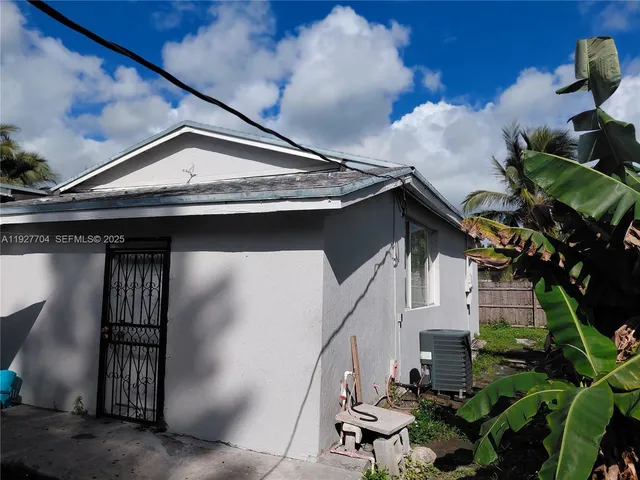 a view of a house with a wooden fence