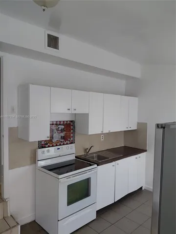 a kitchen with a stove and a refrigerator