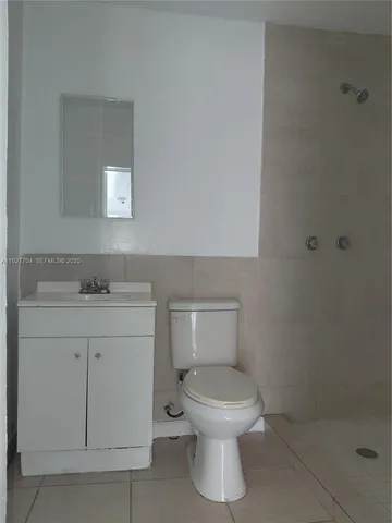 a white toilet sitting next to a bathroom sink