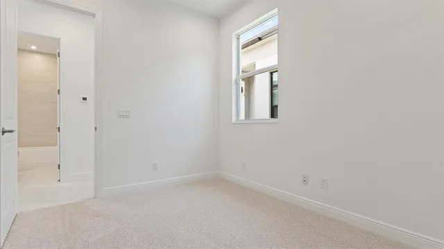 an empty room with windows and closet