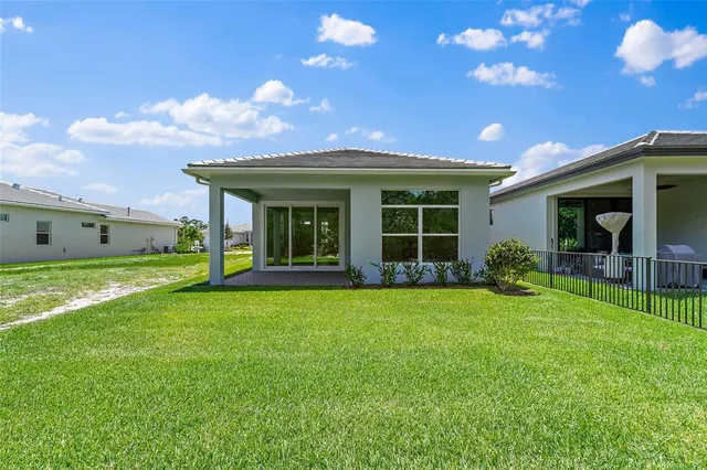 a view of a house with a yard and front view of a house