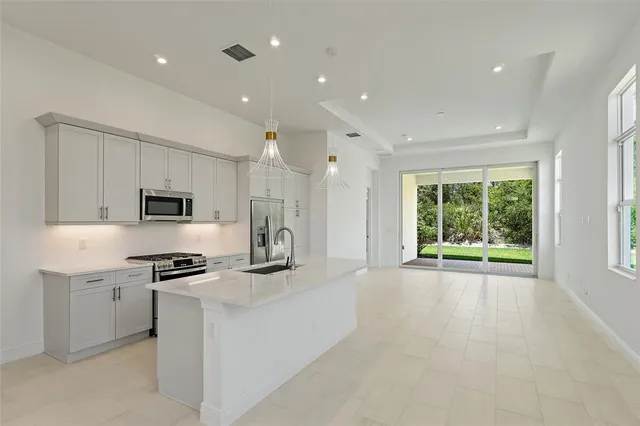 a kitchen with stainless steel appliances granite countertop a sink and a stove