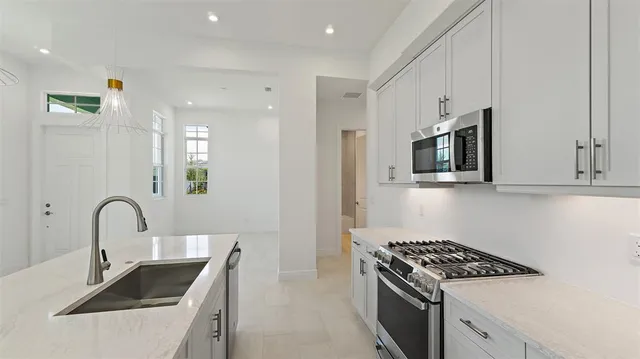 a kitchen with a sink and a stove top oven