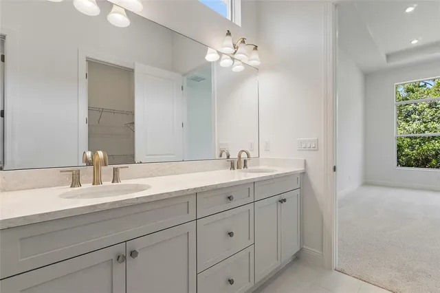 a bathroom with 2 sink and a mirror