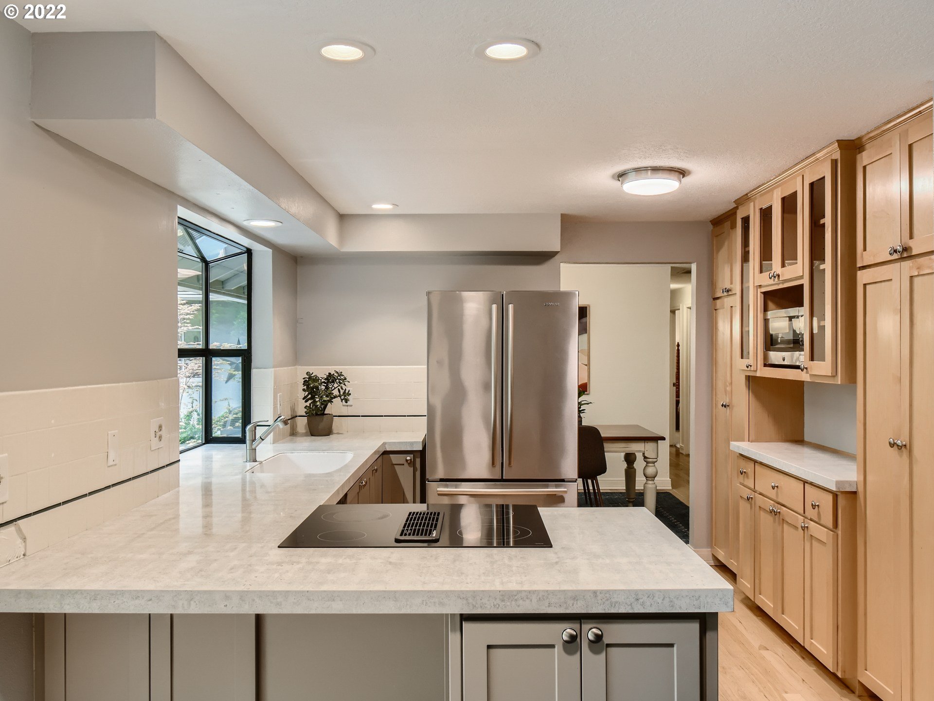 4753 Southwest Dawn Street Lake Oswego, OR 97035 - Photo 12 of 29 a kitchen with stainless steel appliances granite countertop a sink refrigerator and cabinets