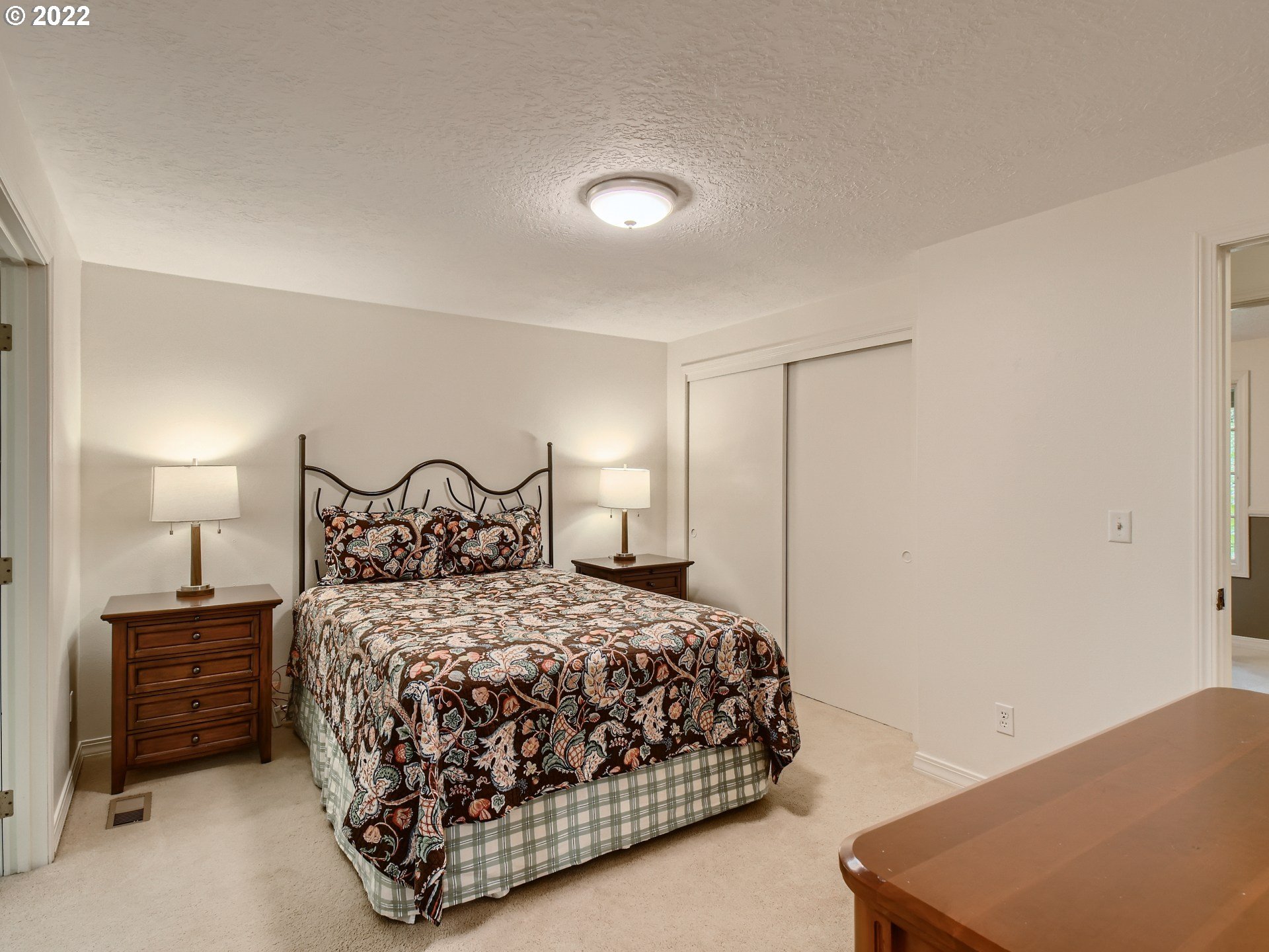 4753 Southwest Dawn Street Lake Oswego, OR 97035 - Photo 16 of 29 a bedroom with a bed and a lamp on dresser