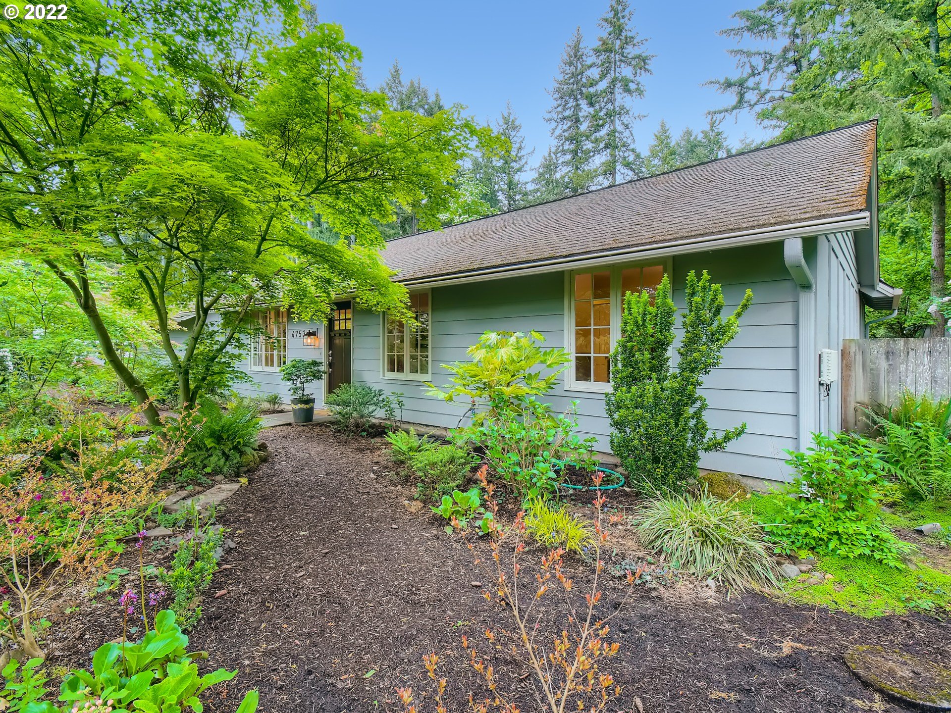 4753 Southwest Dawn Street Lake Oswego, OR 97035 - Photo 2 of 29 a view of a backyard with plants