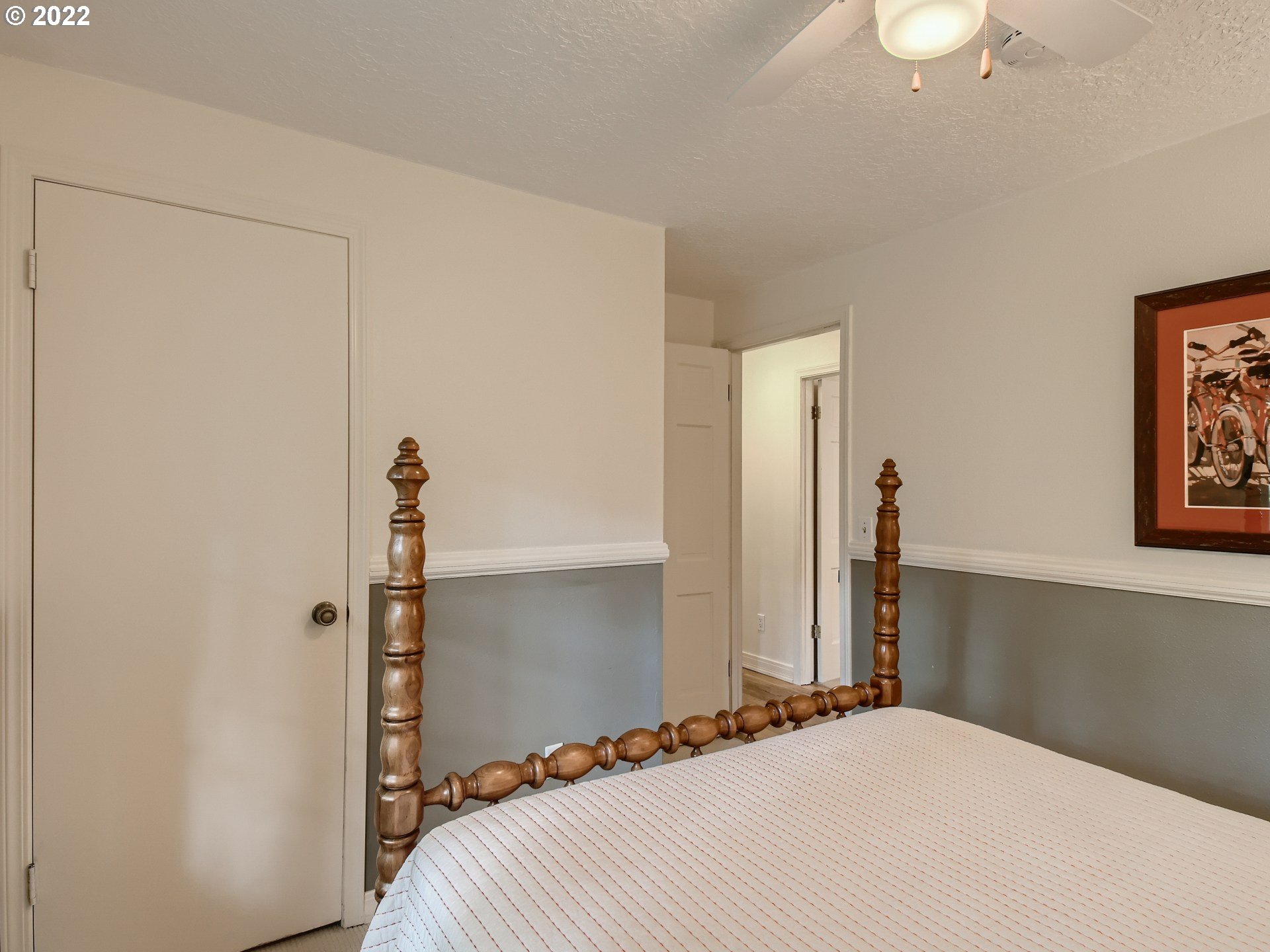 4753 Southwest Dawn Street Lake Oswego, OR 97035 - Photo 22 of 29 a bedroom with a bed and a chandelier
