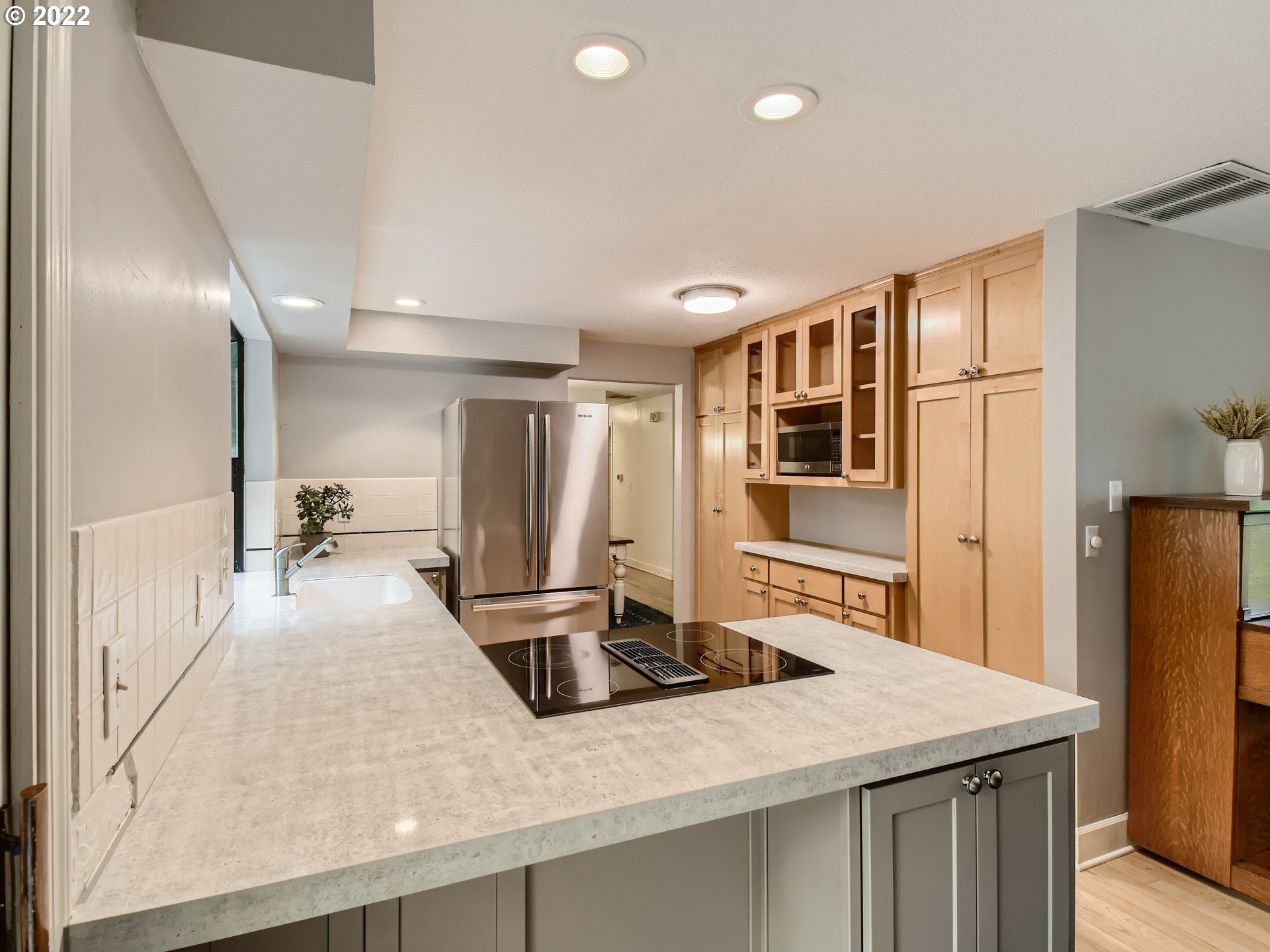 4753 Southwest Dawn Street Lake Oswego, OR 97035 - Photo 10 of 29 a kitchen with stainless steel appliances granite countertop a sink refrigerator and cabinets