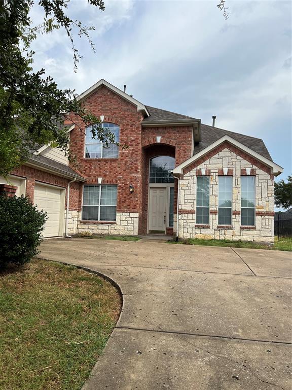 a front view of a building with a garden