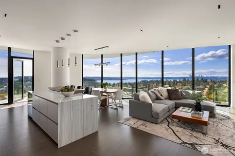 a living room with furniture and floor to ceiling windows