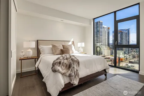 a bathroom with a bathtub sink mirror and shower