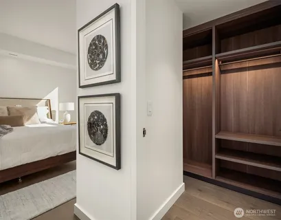 a bedroom with a bed and a lamp next to a window