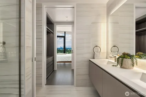a bathroom with a double vanity sink toilet and shower