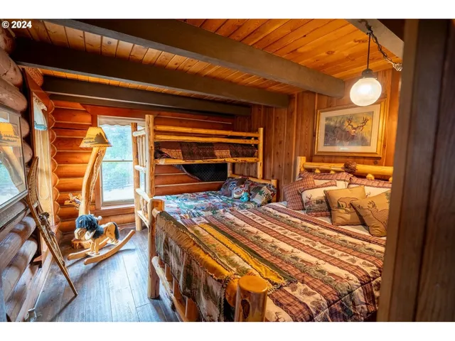 a living room with furniture a flat screen tv and floor to ceiling window