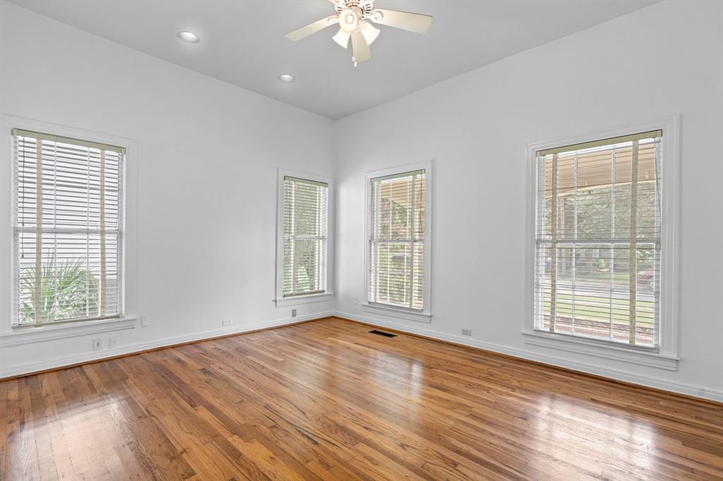 4407 Bonham Street Dallas, TX 75229 - Photo 12 of 22 a view of an empty room with wooden floor and a window