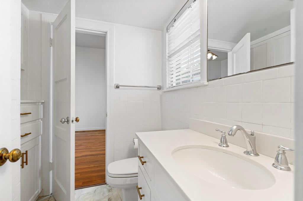 4407 Bonham Street Dallas, TX 75229 - Photo 14 of 22 a bathroom with a sink toilet and shower