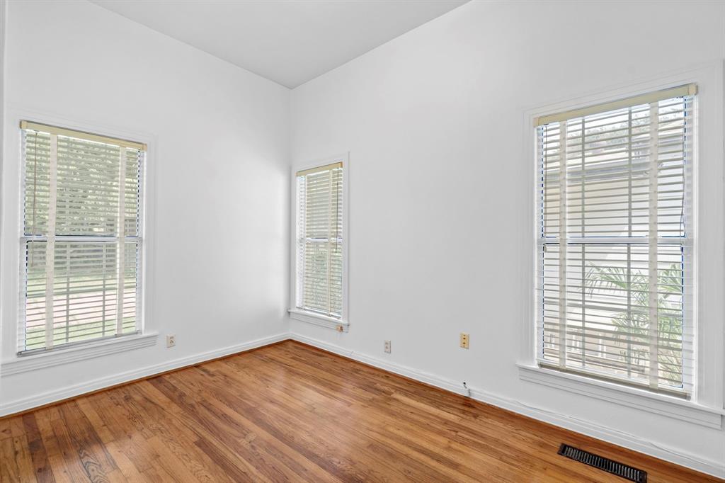 4407 Bonham Street Dallas, TX 75229 - Photo 19 of 22 a view of an empty room with wooden floor and a window