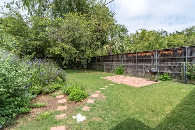 a view of a backyard with a small cabin and a chair