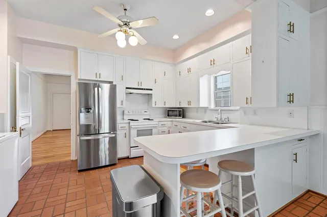 a large kitchen with cabinets and stainless steel appliances