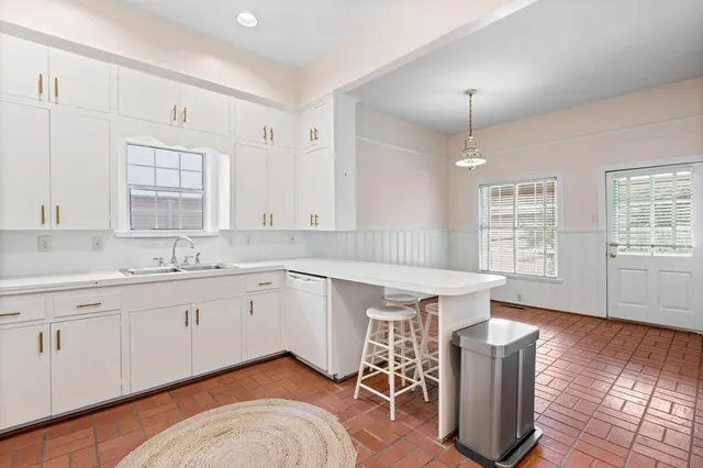 a spacious bathroom with double vanity and a mirror