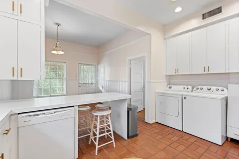 a kitchen with a stove a sink and a refrigerator
