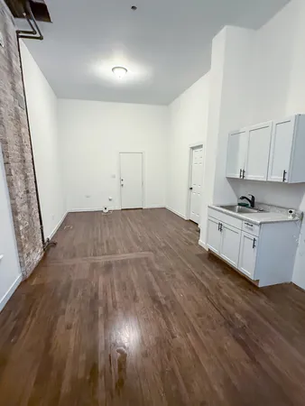 a bedroom with a bed and a sink
