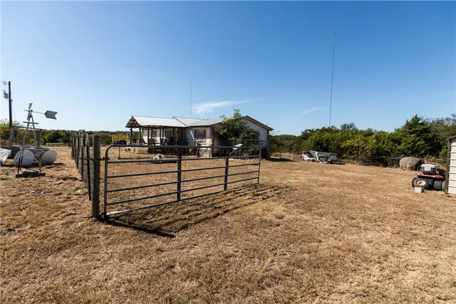 a view of a room with furniture and wooden floor