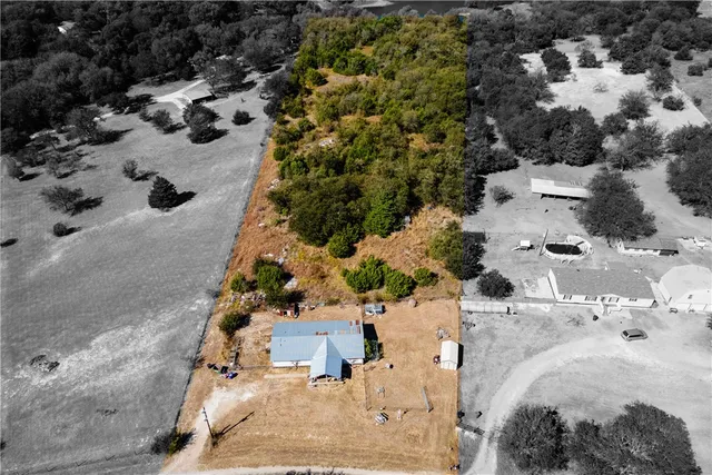 an aerial view of multiple houses with yard