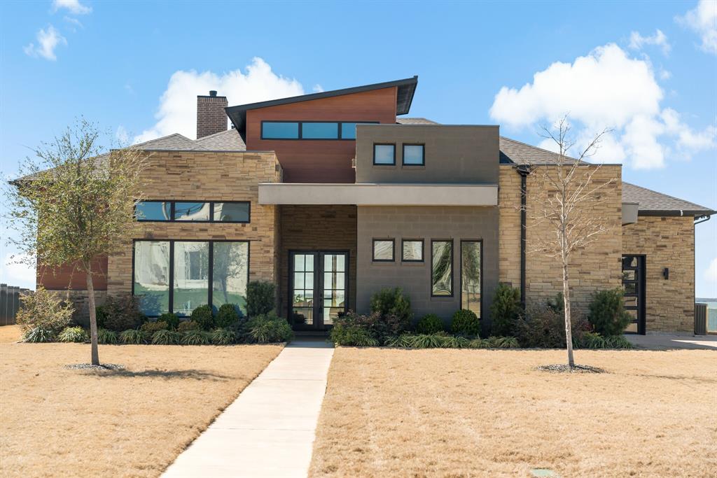 a front view of a building with a garden