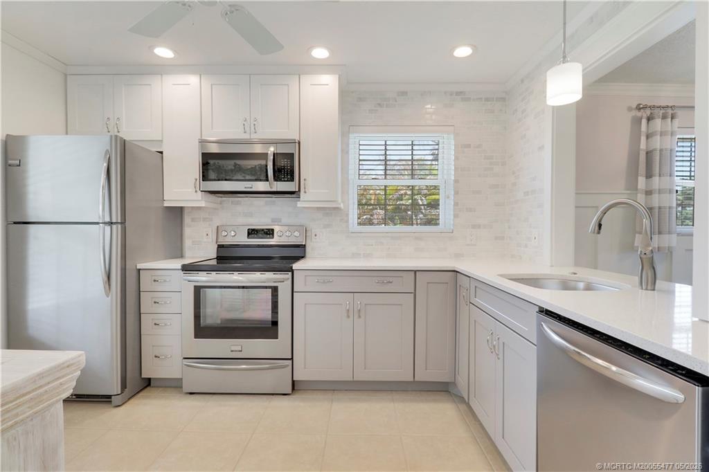 1852 Southwest Palm City Road, Unit 201 Stuart, FL 34994 - Photo 12 of 34 a kitchen with a sink appliances and cabinets