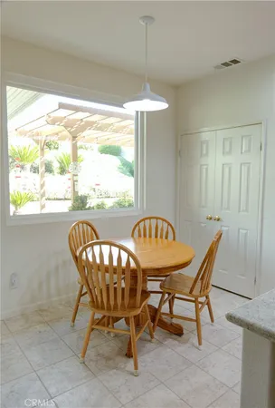 a dining room with furniture and window