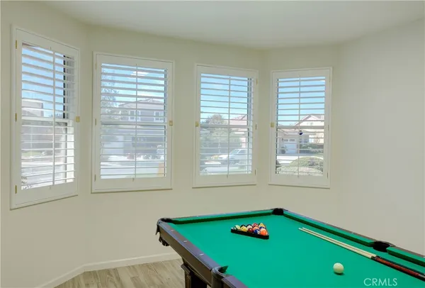 a room with window and pool table