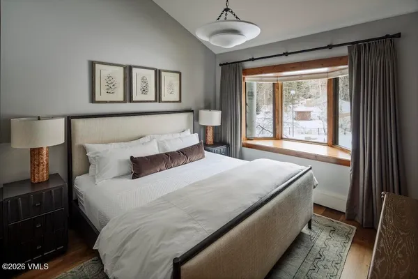 a bedroom with a large bed and a window