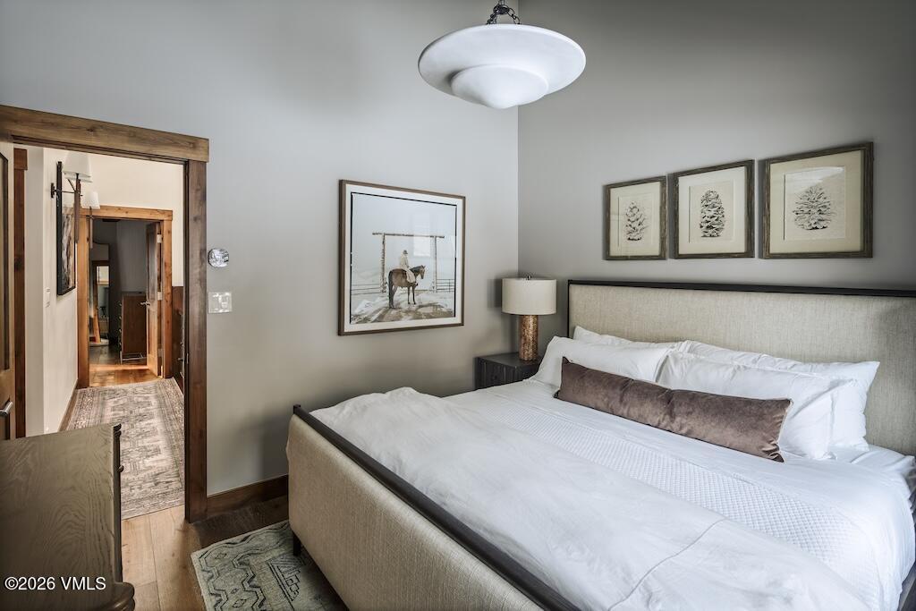 1670 Fallridge Place, Unit 9 Vail, CO 81657 - Photo 12 of 39 a bedroom with a large bed and a chandelier