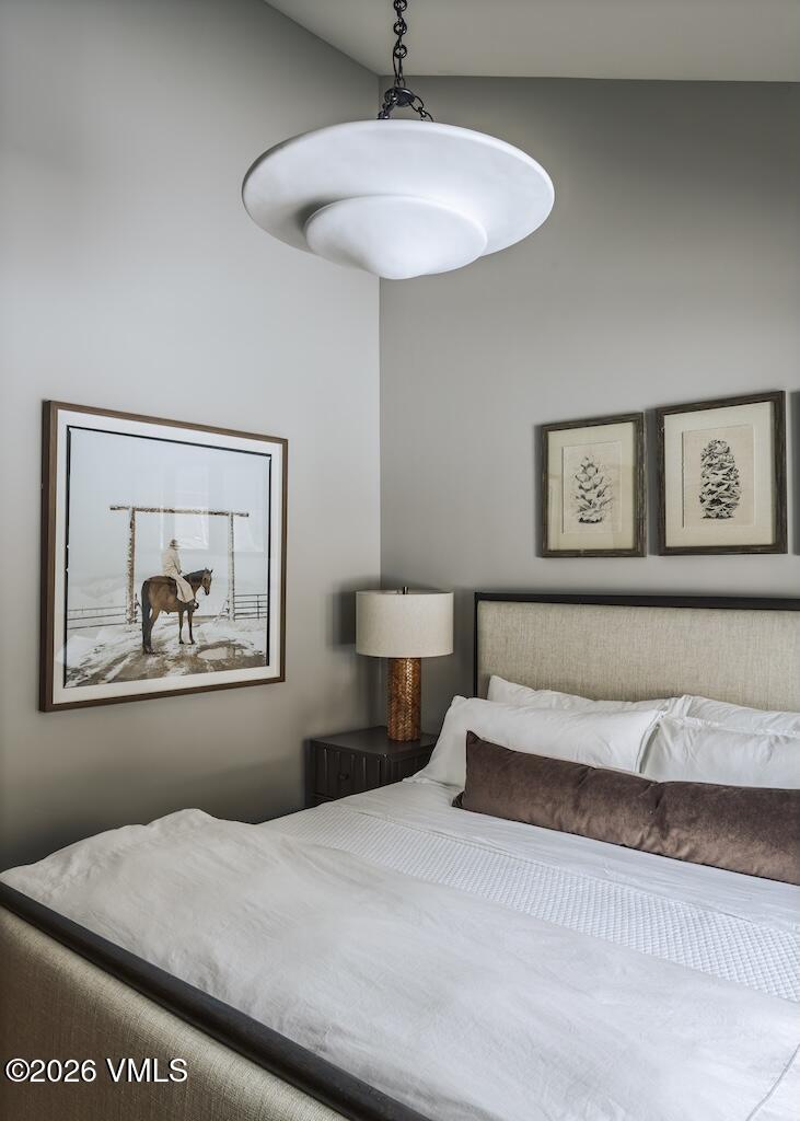 1670 Fallridge Place, Unit 9 Vail, CO 81657 - Photo 13 of 39 a bedroom with a bed and a chandelier