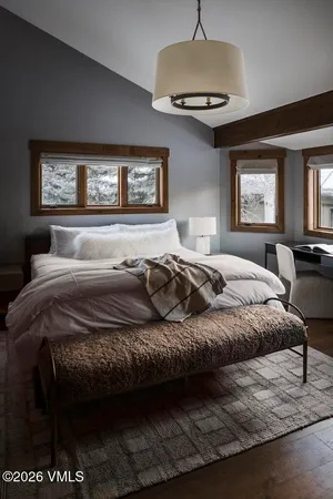 a bedroom with a bed and a window