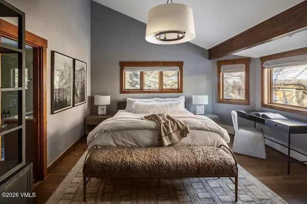 a bedroom with a large bed and a window