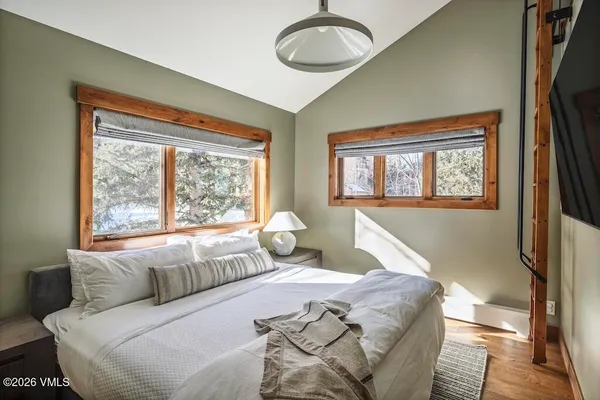 a bedroom with a large bed and a window